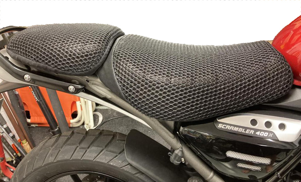 Cool Dry Covers motorbike seat covers feature a unique 3-dimensional mesh which keeps you raised off the seat for added comfort, staying much cooler in the heat and allowing beneficial air circulation. Water flows through without absorbing so you stay drier on the wet days. Sized specifically for your motorbike seat.  Shown here installed on a Triumph Scrambler 400X.